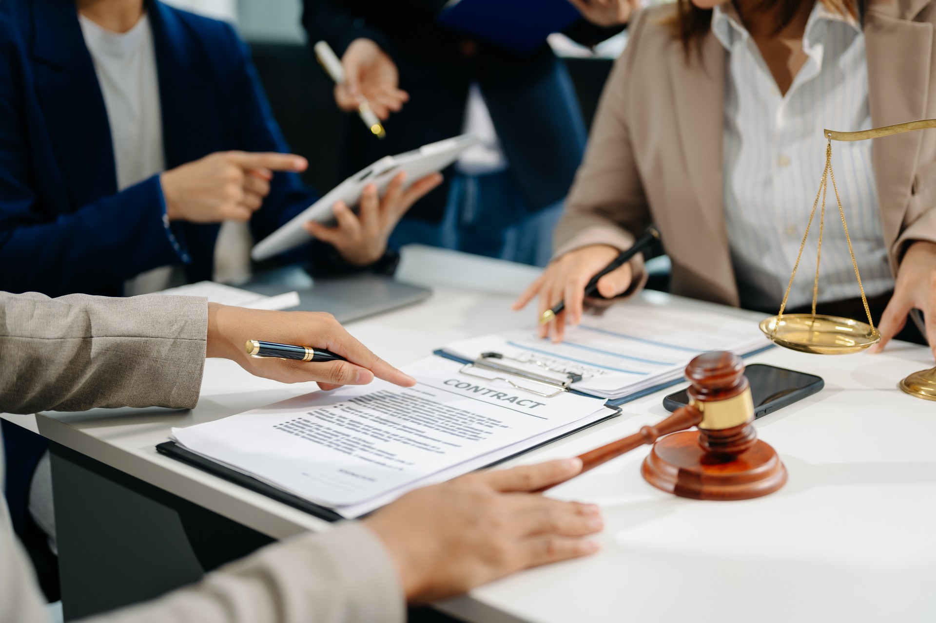 business people and lawyers discussing contract papers sitting at the table. Concepts of law, advice, legal services.