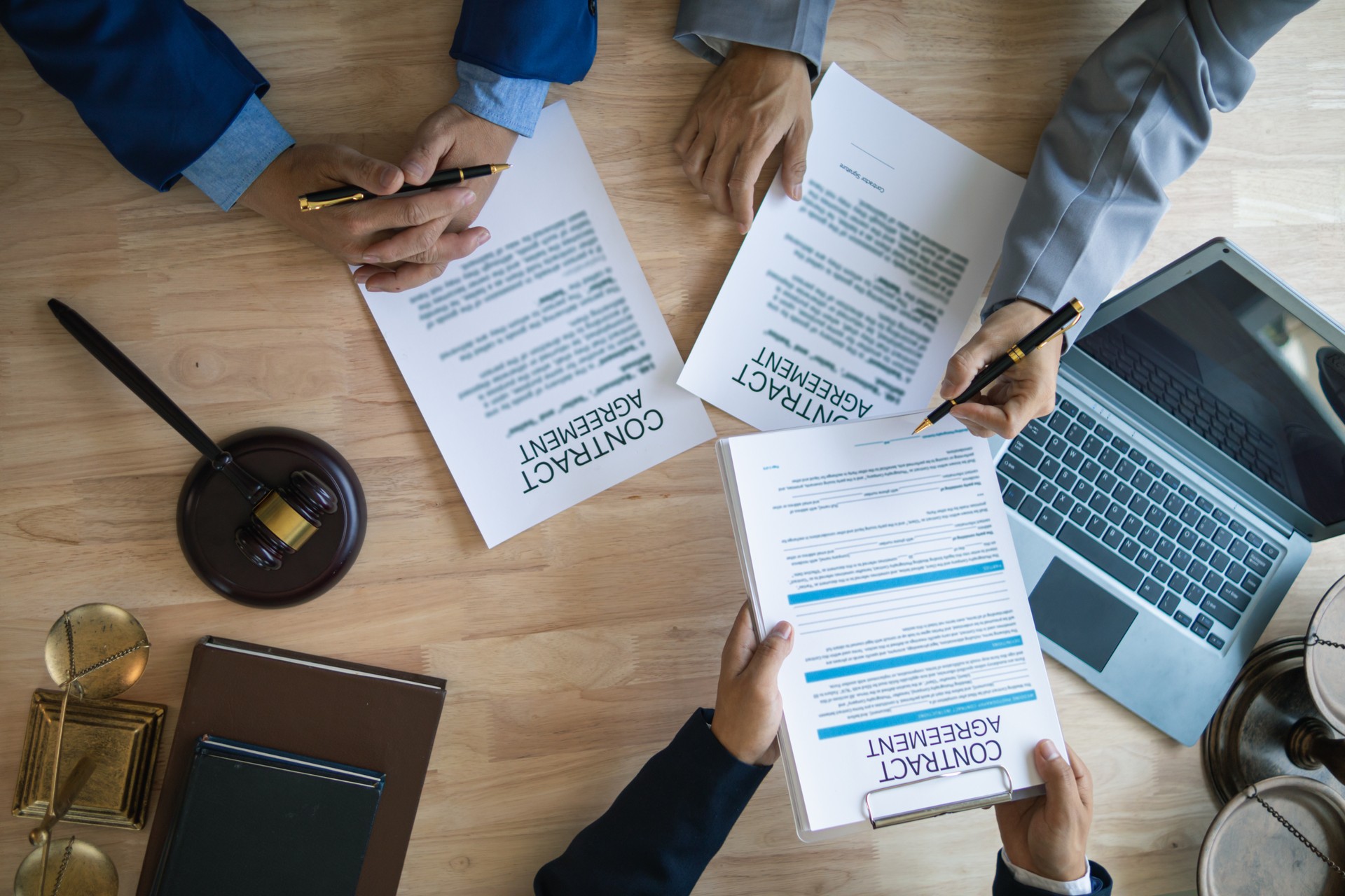 Businessmen and investors discussed joint venture within the legal counsel office and agreed to sign a contract in front of the lawyers within the legal counsel office to witness the joint investment.